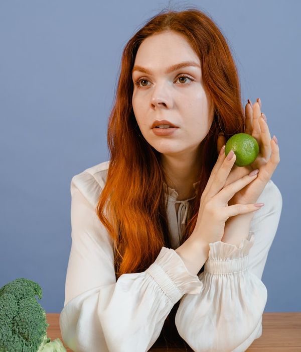 Person stretching peacefully against a lime green background.